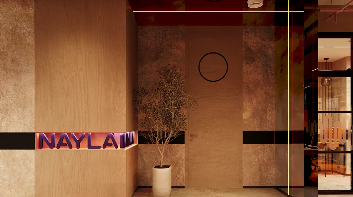 A modern office lobby features a minimalist design with a large, light wood-paneled wall, a potted tree in front of the door, and the name "NAYLA" in illuminated purple letters, enhancing the contemporary and inviting atmosphere.