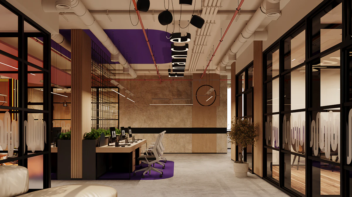 Modern office interior with a sleek design features open workstations, glass partitions labeled "Finance," contemporary furniture, and stylish lighting fixtures against a backdrop of exposed ductwork and neutral tones.