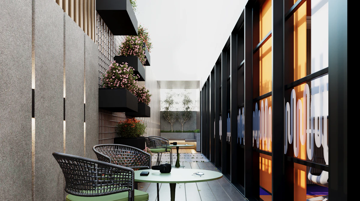 A modern, stylish indoor patio features sleek black-framed floor-to-ceiling windows, two round green tables with matching chairs, and lush potted plants along a textured wall, creating an inviting and contemporary atmosphere.