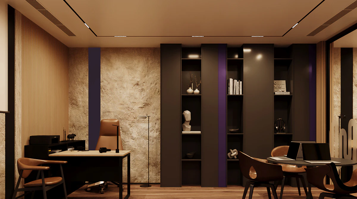 A modern home office with wooden flooring features a sleek desk with a leather chair, minimalist bookshelves filled with decor and books, and a cozy seating area, all lit by stylish ceiling lights.