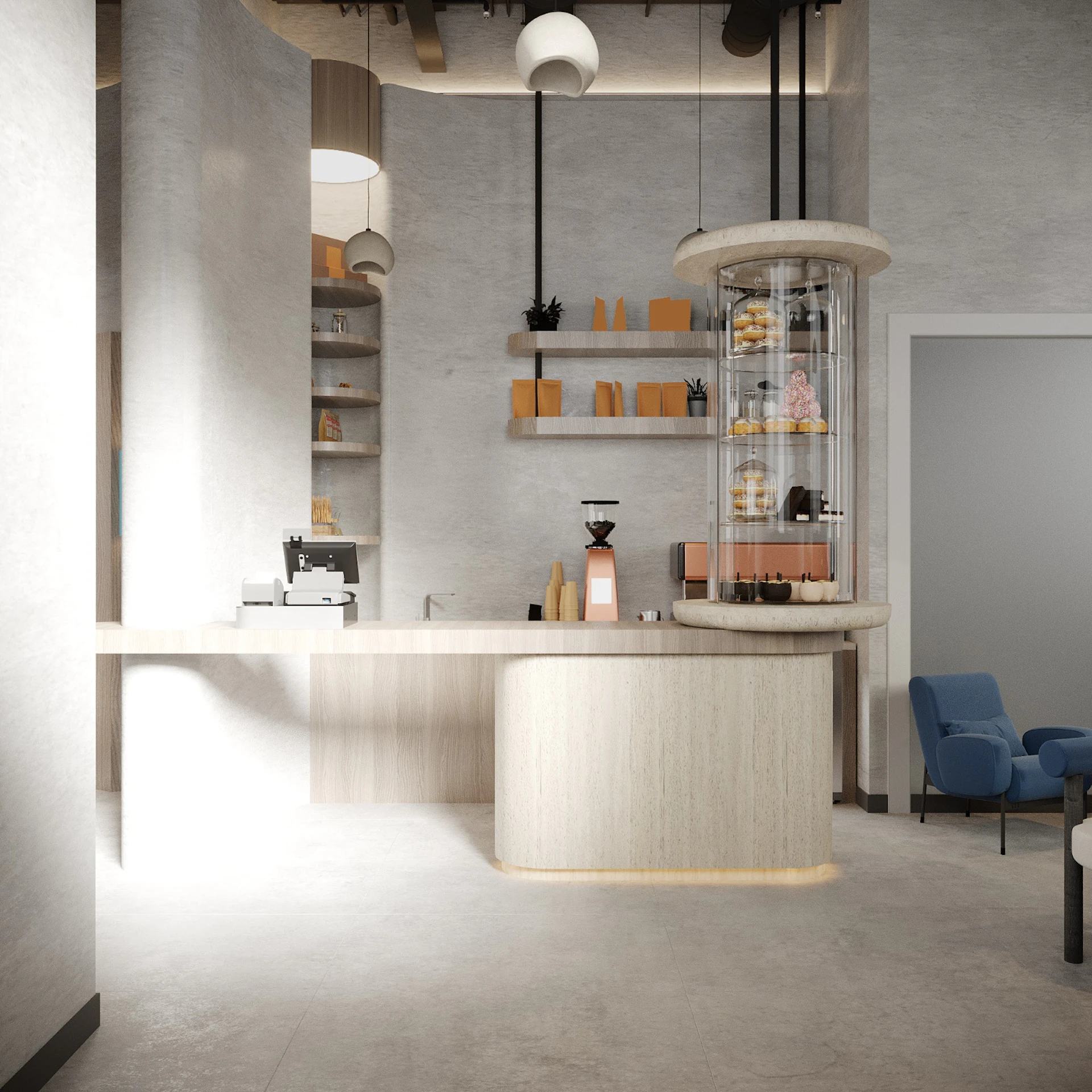 Modern, minimalist café interior with beige and white walls, featuring a circular pastry display, a coffee machine on a light wood counter, floating shelves with decorative items, and a small seating area with blue chairs; this bright, clean design emphasizes contemporary café aesthetics.