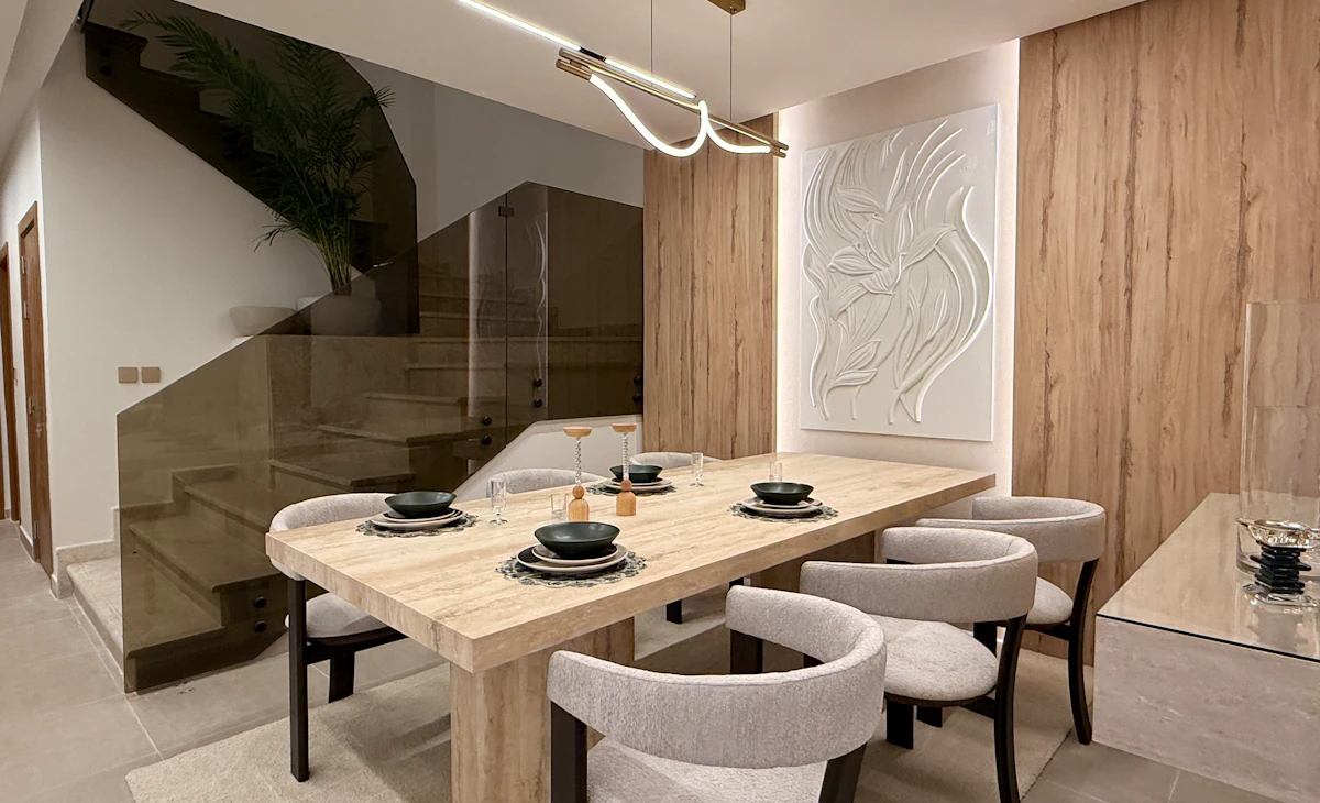dining area with a view from the stairs attached to the living room area