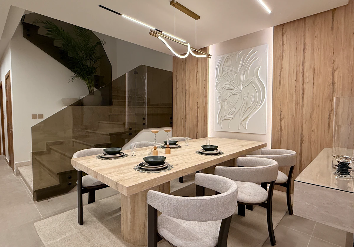 dining area with a view from the stairs attached to the living room area