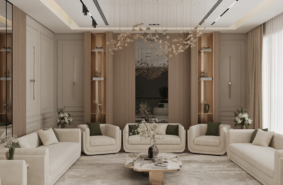 A spacious, elegantly designed living room features a central marble coffee table, surrounded by light beige sofas, with large windows allowing natural light to highlight the minimalist decor and hanging modern chandelier.