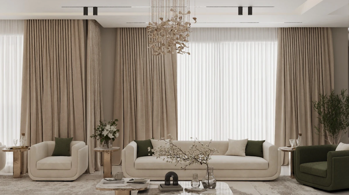 A modern living room features elegant beige sofas with dark green accent pillows, a luxurious crystal chandelier, and large windows draped with floor-length curtains, creating a sophisticated and inviting space.