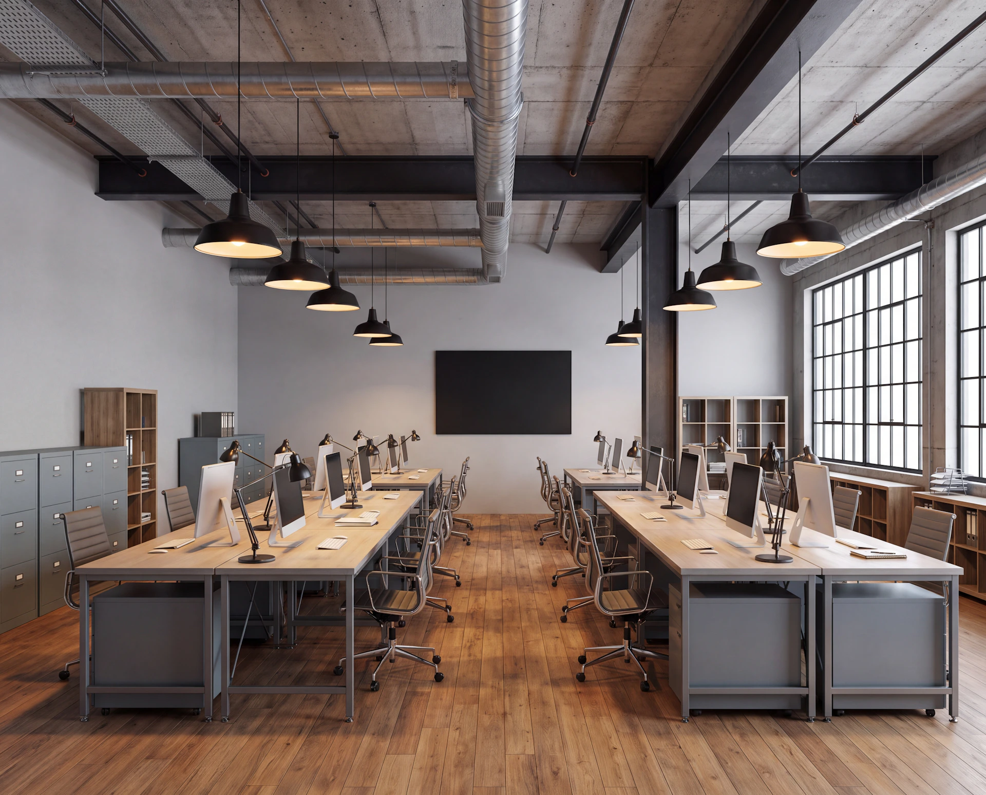 Industrial-style office with parquet flooring, large windows, aligned wooden desks with iMac computers, steel filing cabinets, suspended lighting, and exposed ventilation ducts